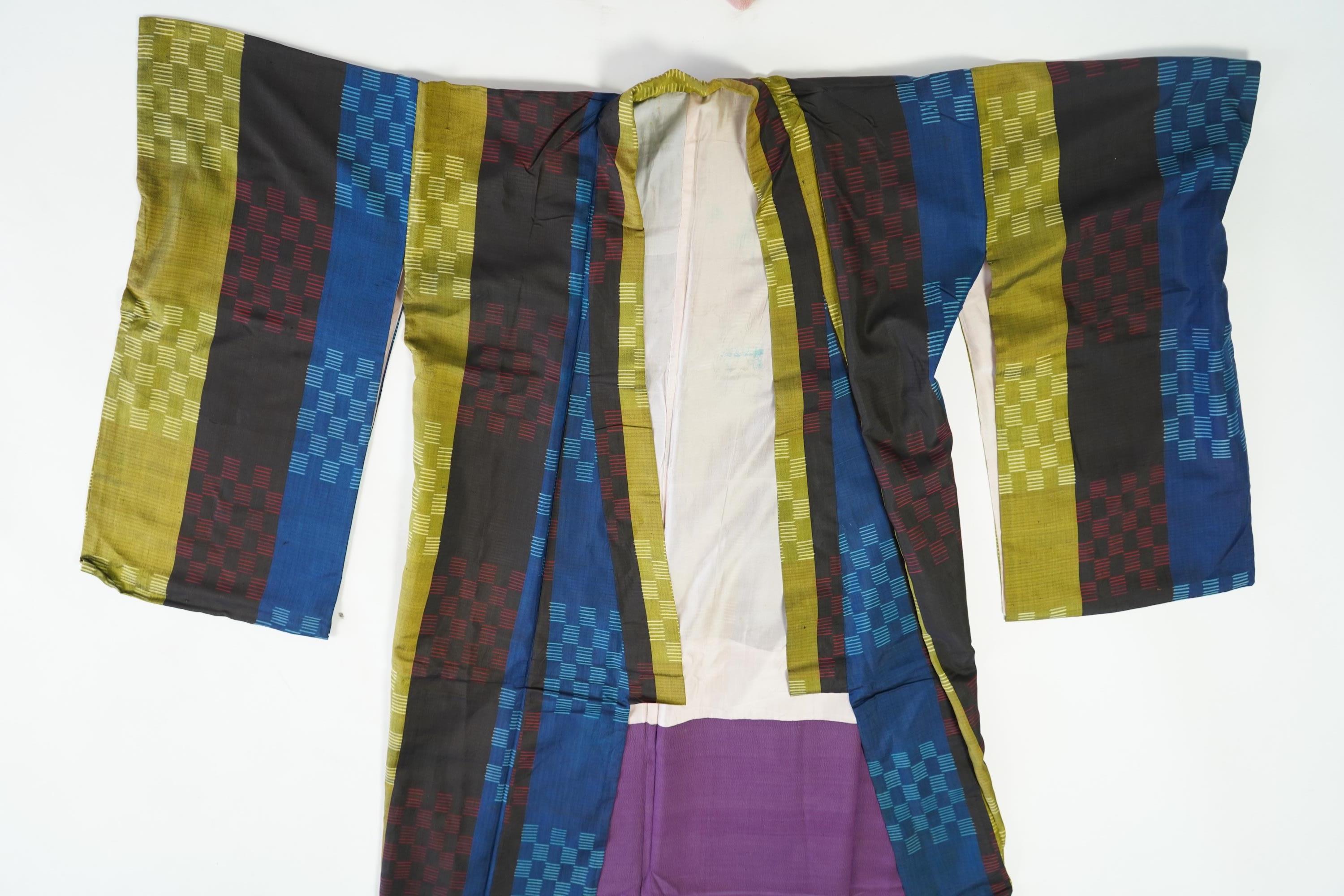Four 1930’s - 1950’s printed silk full length silk lined Japanese kimonos. Two floral and two geometric in design. Longest black and orange floral designed kimono, 150cm long. Condition - purple and pink check kimono the